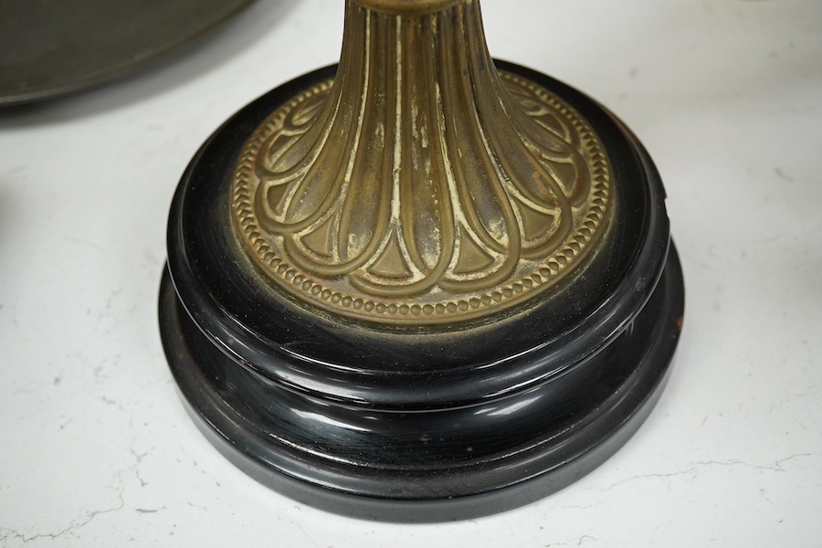 A late 19th century brass and glass oil lamp with later shade, 56cm high. Condition - chip to base and shade cut down